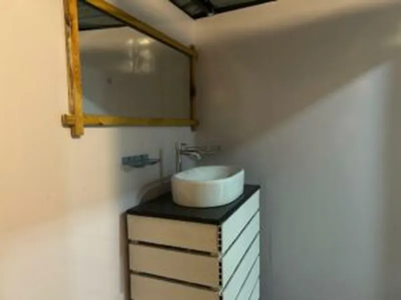 Attached bathroom with washbasin at Purnam Yogashala Goa